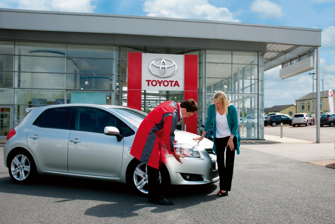 Man and woman inspecting car